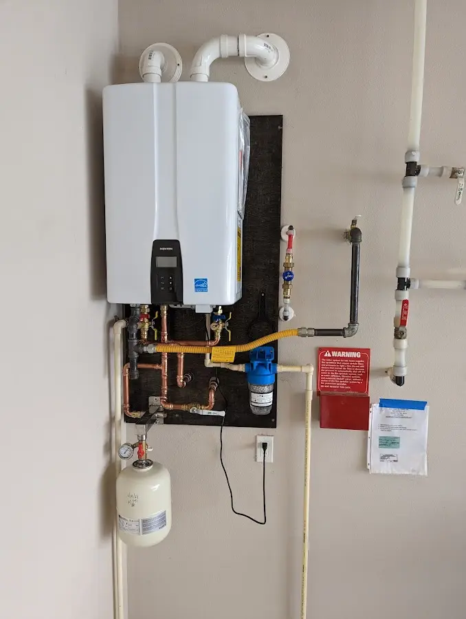 Professional plumber installing copper piping in a Waterford home